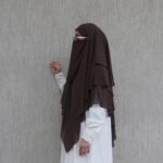3-layer chiffon khimar in lightweight fabric, offering full coverage with elegant layered design.